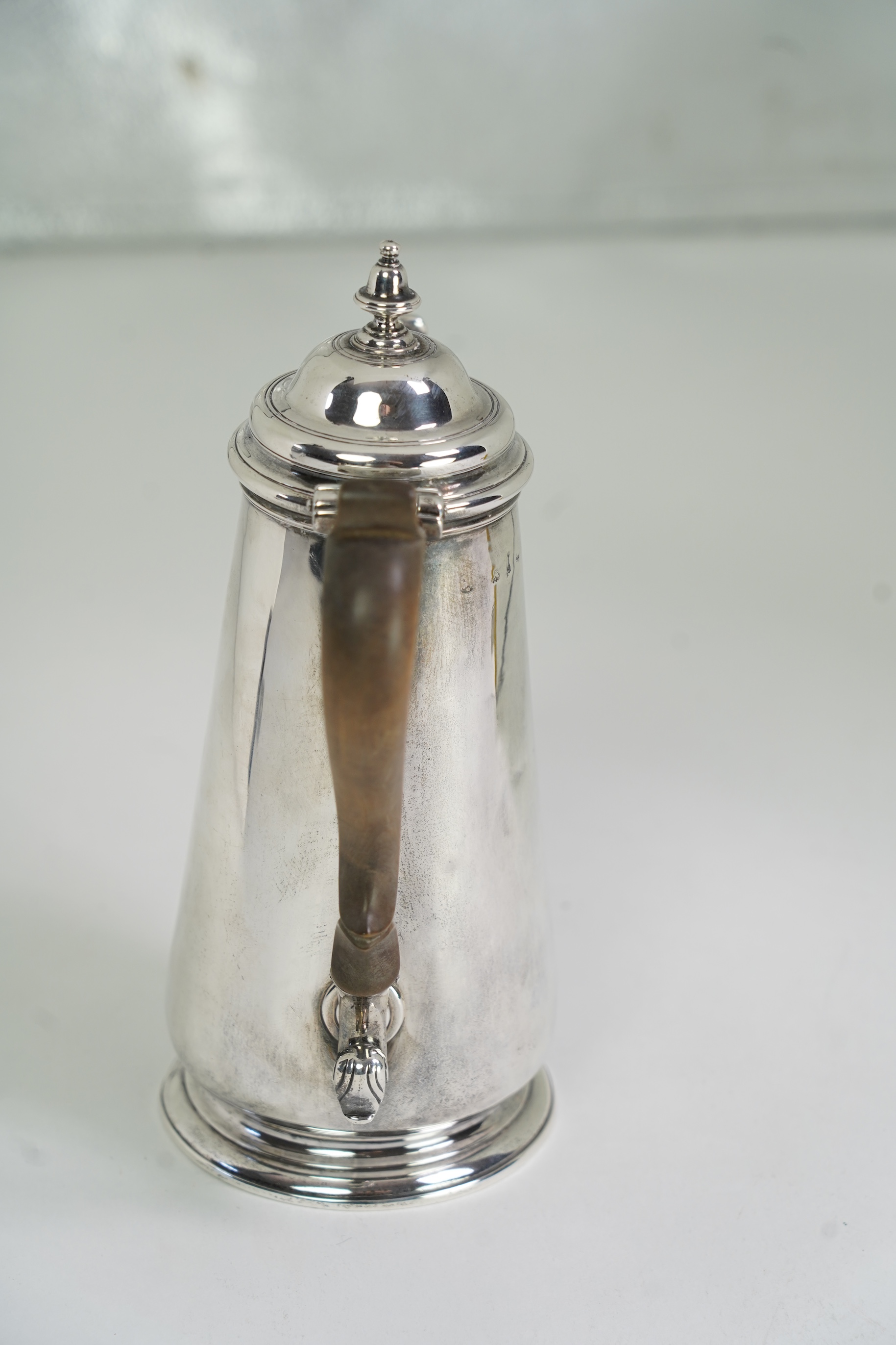 A mid 18th century silver coffee pot, marks very rubbed